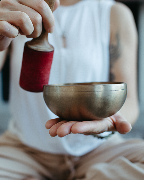a person holding a sound bowl